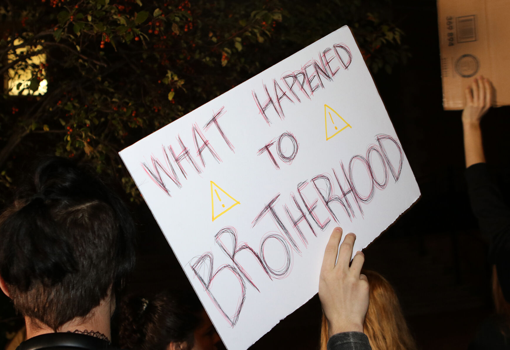 Kane Kruse, a freshman at Missouri, holds up a sign reading “what happened to brotherhood”